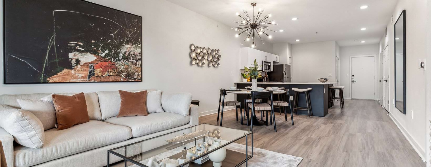 Open concept living room, dining room, and kitchen area in our modern apartments in Fort Worth at Broadstone on Trinity.